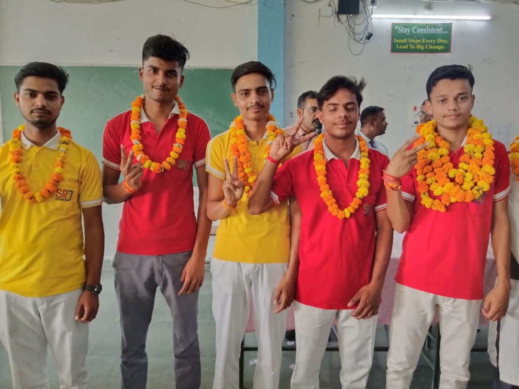 SRJ Academy students celebrating board results with garlands