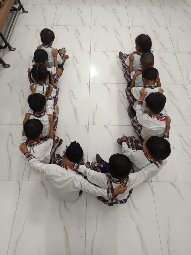 SRJ Academy students forming letter U