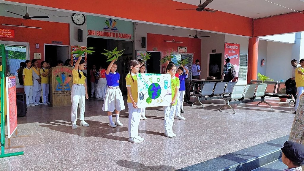 SRJ Academy Earth Day group with Earth poster and school sign
