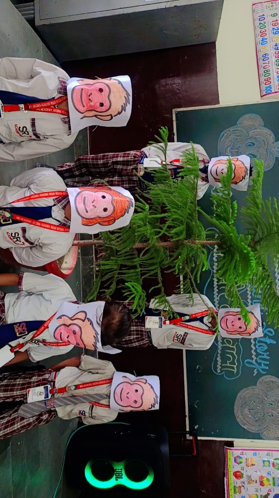 SRJ Academy students in monkey masks around a classroom tree