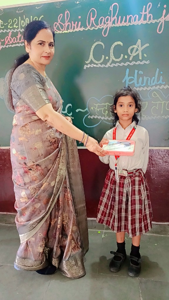 Teacher presenting a gift to a student at SRJ Academy CCA